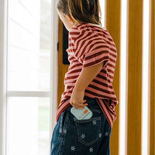 Girl with a Waffle Go kids phone tucked in her back pocket